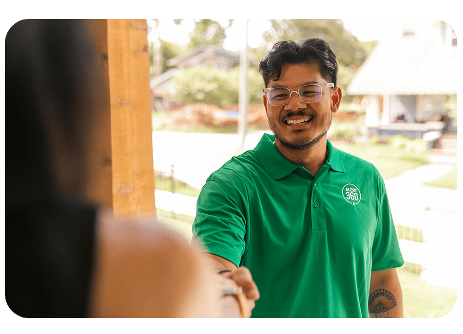 Smiling Alert 360 representative shaking hands with customer