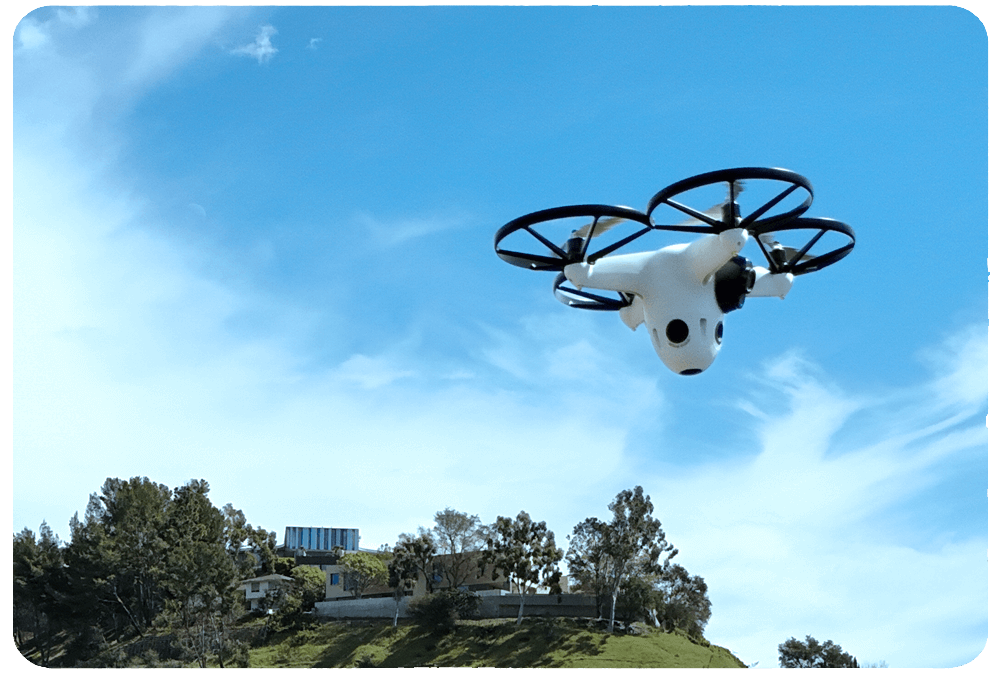 Drone flies over neighborhood, highlighting perimeter defense for security systems