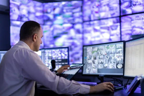 A Person Working in a Surveillance Control Room