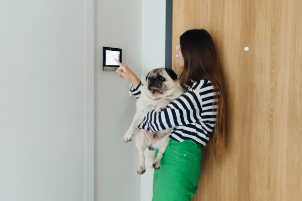 A Woman Using a Smart Home Control Panel in Phoenix, AZ